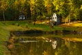 Autumn landscape with lake and stone water mill. Royalty Free Stock Photo