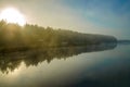 autumn landscape. Mist over the river and trees. Forest in the fog. Backlight sunlight. Beautiful sunrise in the clear sky Royalty Free Stock Photo