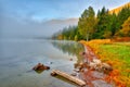 Autumn landscape in the mountains with trees reflecting in the water at St. Ana`s lake, Romania Royalty Free Stock Photo