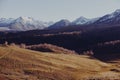 Autumn landscape of the nature of the mountains on a trip with snow-capped winter peaks in the background, off roads Royalty Free Stock Photo