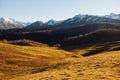 Autumn landscape of the nature of the mountains on a trip with snow-capped winter peaks in the background, off roads Royalty Free Stock Photo