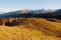 Autumn landscape of the nature of the mountains on a trip with snow-capped winter peaks in the background, off roads Royalty Free Stock Photo