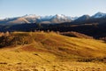 Autumn landscape of the nature of the mountains on a trip with snow-capped winter peaks in the background, off roads Royalty Free Stock Photo