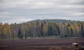Autumn landscape with an old iron tractor in a peat bog Royalty Free Stock Photo