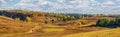 Autumn landscape, panorama, background - view of the valley with dirt rural road surrounded by wooded hills Royalty Free Stock Photo