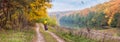 Autumn landscape, panorama, banner - the cyclist near lake who watching flight of the harrier