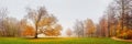 Autumn landscape, panorama, banner - view of a foggy autumn park with paths and fallen leaves Royalty Free Stock Photo