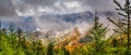 Autumn landscape, panorama, banner - view of mountains covered with mountain forests and meadows under autumn sky after rain Royalty Free Stock Photo