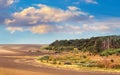 Autumn landscape: plowed field near the forest, picturesque sky with curly clouds Royalty Free Stock Photo