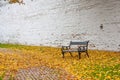 Autumn landscape in rainy day - view of the bench and walkway in park Royalty Free Stock Photo