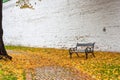 Autumn landscape in rainy day - view of the bench and walkway in park Royalty Free Stock Photo