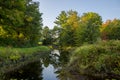 Autumn landscape with river and colorful trees in the park. Nature landscape view of a mountain river in a coniferous forest Royalty Free Stock Photo