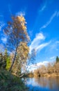 Autumn landscape with the river, the forest and the blue sky