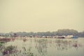 Autumn landscape on a river, on a rainy, foggy day; retro