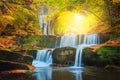 Autumn landscape - river waterfall in colorful autumn forest with old bridge Royalty Free Stock Photo