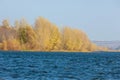 Autumn landscape,   river, windy weather, dark blue water, yellow-red autumn leaves on trees, last warm days Royalty Free Stock Photo