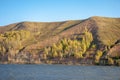 Autumn landscape, river,   windy weather, dark blue water, yellow-red autumn leaves on trees, last warm days Royalty Free Stock Photo