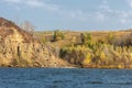 Autumn landscape, river,  windy weather, dark blue water, yellow-red autumn leaves on trees, last warm days Royalty Free Stock Photo