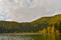 Autumn landscape. Saint Ana lake in Romania, the only volcanic lake in Europe, formed in a crater of a dead volcano Royalty Free Stock Photo