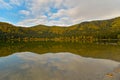 Autumn landscape. Saint Ana lake in Romania, the only volcanic lake in Europe, formed in a crater of a dead volcano Royalty Free Stock Photo