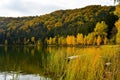 Autumn landscape. Saint Ana lake in Romania, the only volcanic lake in Europe, formed in a crater of a dead volcano Royalty Free Stock Photo