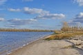Autumn landscape on the sandy shore of the great river. Royalty Free Stock Photo