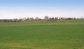 Autumn landscape with seeded field and village Royalty Free Stock Photo