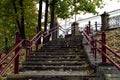 Autumn landscape: a staircase strewn with autumn leaves in a city park against the backdrop of yellow maples, close-up Royalty Free Stock Photo