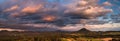 Autumn landscape at sunset - mountains, forests and dramatic clouds illuminated by the setting sun