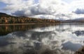 Autumn landscape on the taiga Siberian river with the reflection of the sky on the surface of clear water