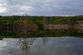 Autumn landscape. Trees with fallen leaves are reflected in the calm water of the lake Royalty Free Stock Photo