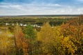 Autumn landscape: trees with yellow leaves grow on the banks of a cold autumn river amid dark skies Royalty Free Stock Photo