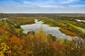 Autumn landscape: trees with yellow leaves grow on the banks of a cold autumn river amid dark skies Royalty Free Stock Photo