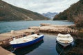 Autumn landscape. Two fishing boats on the water in a small harbor on a cloudy day. Montenegro, Kotor Bay Royalty Free Stock Photo