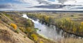 Autumn landscape - the winding river over the meadows between hills and forests Royalty Free Stock Photo