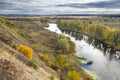 Autumn landscape - the winding river over the meadows between hills and forests Royalty Free Stock Photo