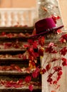 Autumn leaf fall. Red and yellow leaves on the destroyed old stone steps burgundy (marsala color) hat. Royalty Free Stock Photo