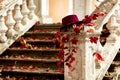 Autumn leaf fall. Red and yellow leaves on the destroyed old stone steps burgundy (marsala color) hat. Royalty Free Stock Photo