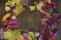 Autumn leaf on wood black background top view orange leaf on old grunge wood deck, copy place for inscription, tablet for text