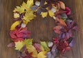 Autumn leaf on wood black background top view orange leaf on old grunge wood deck, copy place for inscription, tablet for text