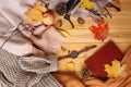 Autumn leaves, an apple, cozy scarves and knitted sweaters, an e-book, flat, the concept of a hugg, winter or autumn mood