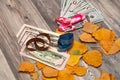 Autumn leaves with a beautiful dollar gift. Royalty Free Stock Photo