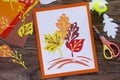 Autumn leaves of colored paper on a wooden background. Royalty Free Stock Photo