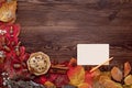 Autumn leaves, cookies, tea and greeting card on wooden background Royalty Free Stock Photo