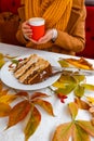 Autumn leaves cup coffee thanksgiving fruit woman hands hold cake red yellow Royalty Free Stock Photo