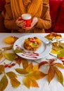 Autumn leaves cup coffee thanksgiving fruit woman hands hold cake red yellow Royalty Free Stock Photo