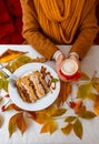 Autumn leaves cup coffee thanksgiving fruit woman hands hold cake red yellow Royalty Free Stock Photo