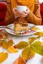 Autumn leaves cup coffee thanksgiving fruit woman hands hold cake white red yellow Royalty Free Stock Photo