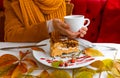 Autumn leaves cup coffee thanksgiving fruit woman hands hold cake white red yellow Royalty Free Stock Photo