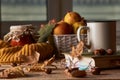 Autumn leaves, cup of coffee, warm scarf, fruits basket and book Royalty Free Stock Photo